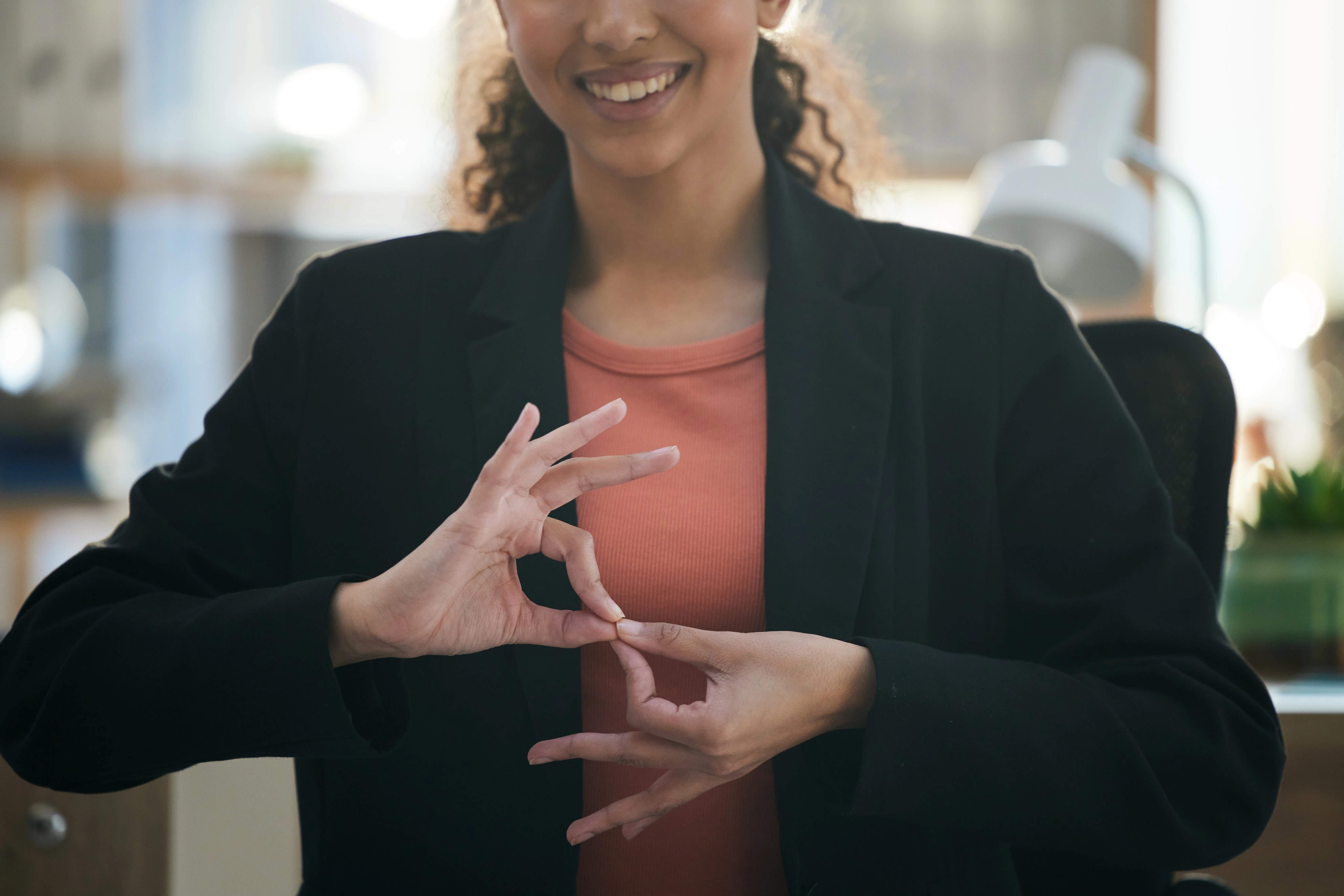 woman making using sign language in an office environment
